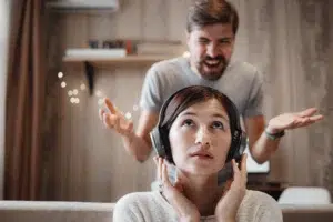 angry-husband-shouting-at-wife-sitting-on-sofa-and