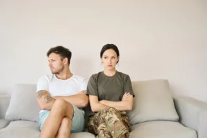 conflicting-couple-sitting-on-sofa-in-closed-poses